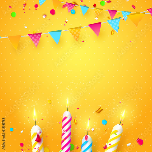 Colorful sparkling candles and birthday garland on orange background.