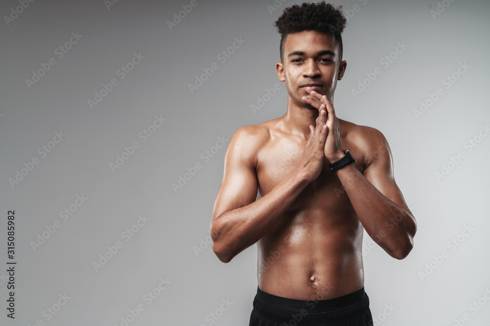 Photo of african american man looking at camera while working out