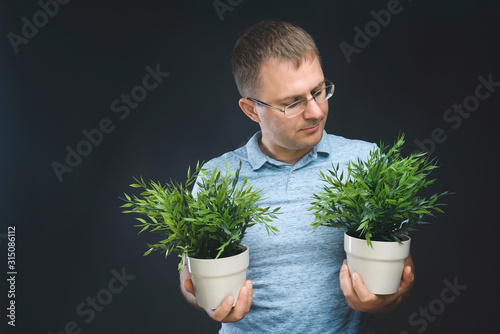 man looking on green plant