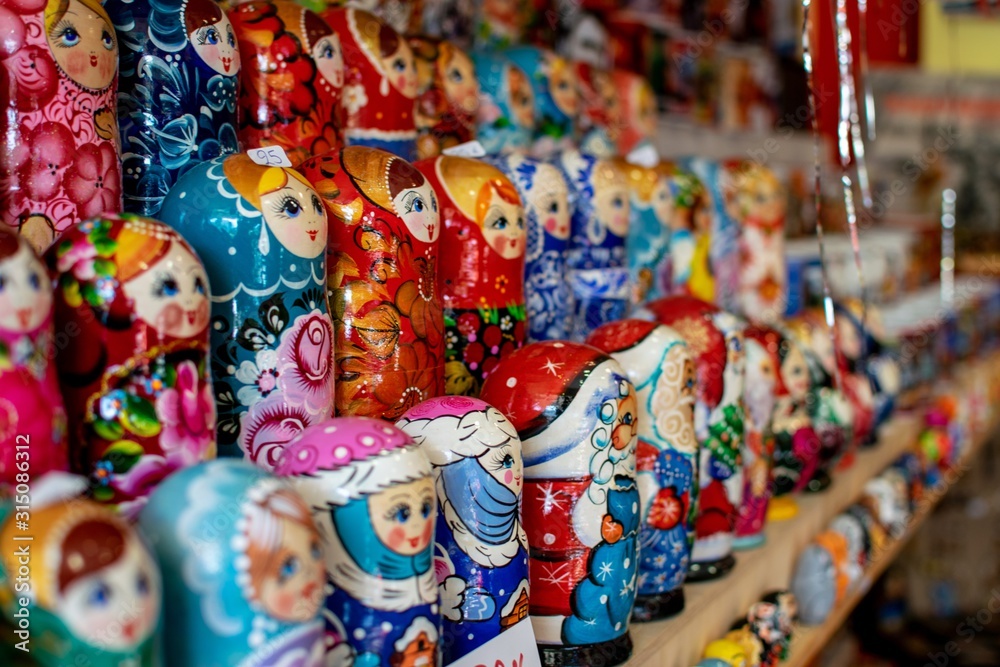 Babushkas traditional Russian dolls on a shelf in a tourist souvenir shop.