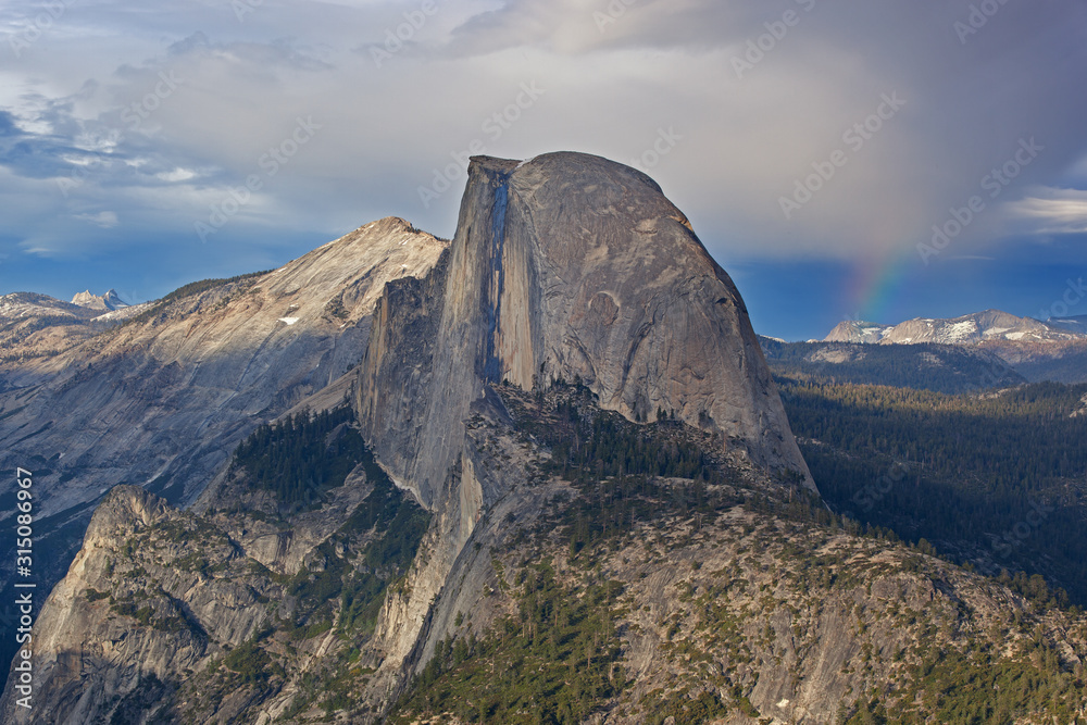 Landscape of a rainbow, Half Dome and the Sierra Nevada Mountains from Glacier Point, Yosemite National Park, California, USA
