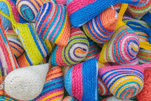 Close up to vintage handicraft colorful bags by yarn for sale at local market in Thailand. Selective focus.