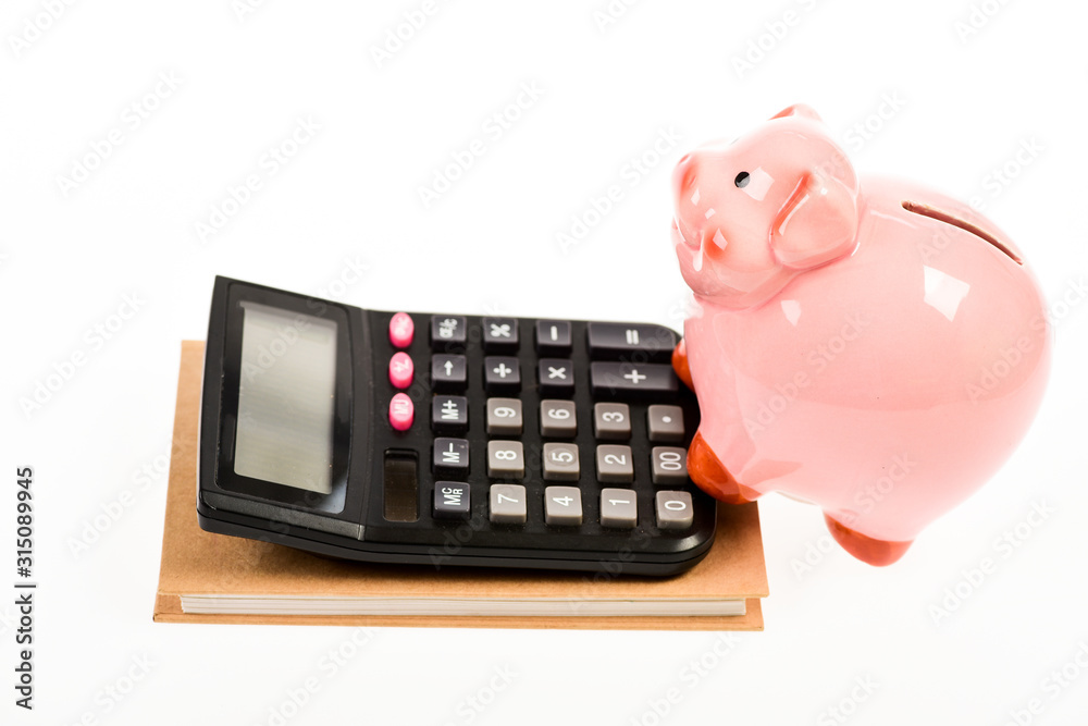 Piggy bank money savings. Piggy bank pink pig and calculator. Exchange rates. Economics and business administration. Credit debt concept. Economics and profit management. Economics and finance Piggy bank money savings. Piggy bank pink pig and calculator. Exchange rates. Economics and business administration. Credit debt concept. Economics and profit management. Economics and finance