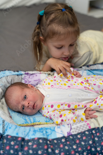 Sisters newborn and five years old