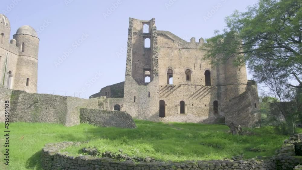 Camera pan left from the Palace of Iyasu I to reveal Fasilides Castle within the Fasil Ghebbi royal enclosure complex in Gondar, Ethiopia Camera pan left from the Palace of Iyasu I to reveal Fasilides Castle within the Fasil Ghebbi royal enclosure complex in Gondar, Ethiopia