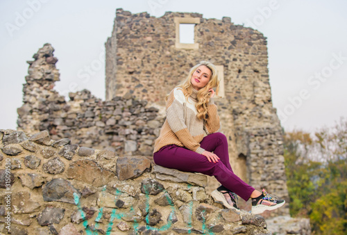 Travel destinations. Woman makeup face sit on stony ruins background defocused. Tourism concept. Explore midcentury castle ruins. Fashionable girl tourist. Vacation and travel. Travel agency