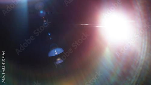 Lens flare light and bright glow over black background. Abstract overlay filter
