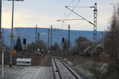 Railway track with signals and mountains in the background