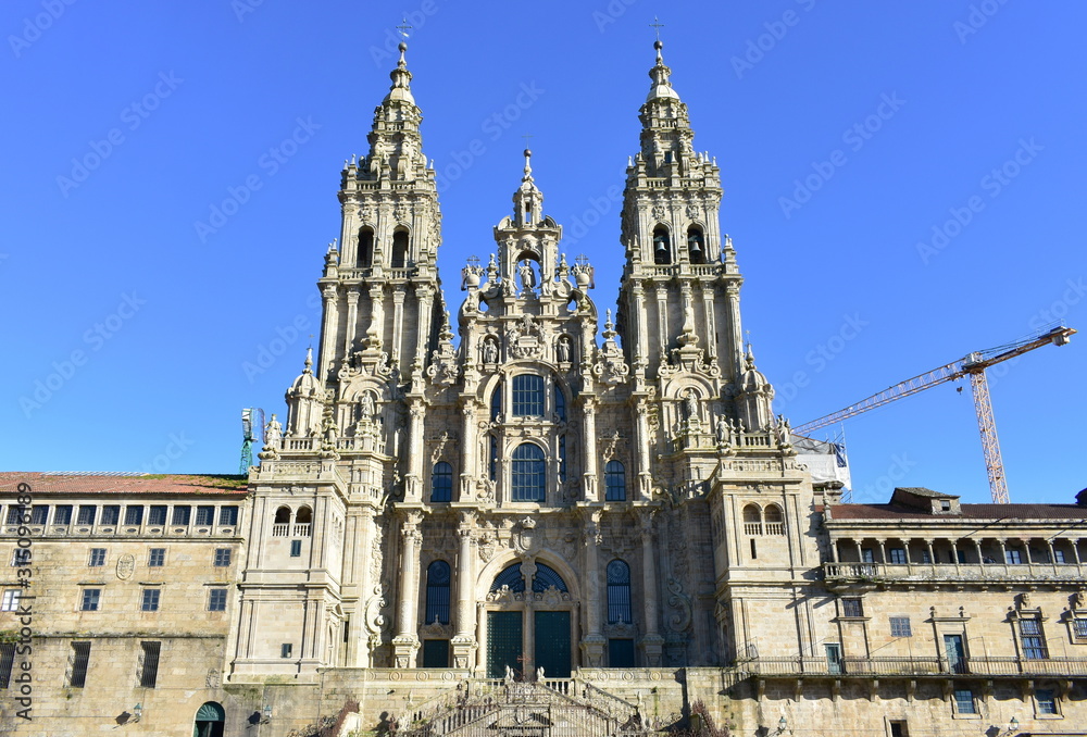 Cathedral, baroque facade and towers from Praza do Obradoiro with blue sky. Santiago de Compostela, Spain.