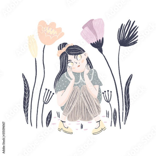 Girl sitting and dreaming while looking at beautiful flowers photo