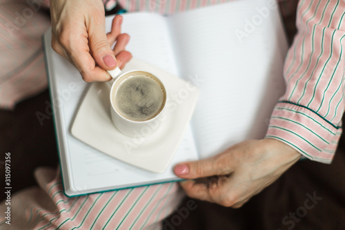 coffee time in bed  girl in pajamas with espresso