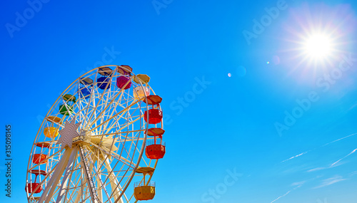 Ferris wheel on Mount Tibidabo Spain Barcelona. Sunny day with blue sky aerial view.