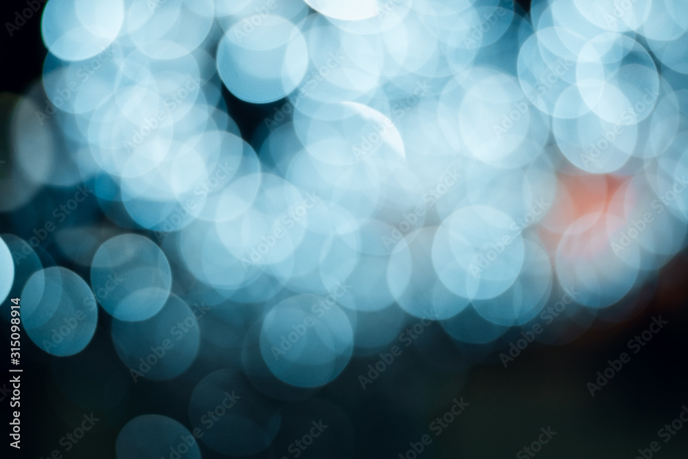 Abstract bright blured colored bokeh. Lights of the night city background.