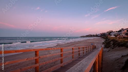 Wild beach with sandy dunes at sunset by the Mediterranean Sea in Valencia Spain