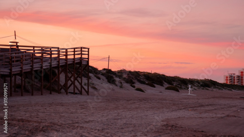 Wild beach with sandy dunes at sunset by the Mediterranean Sea in Valencia Spain