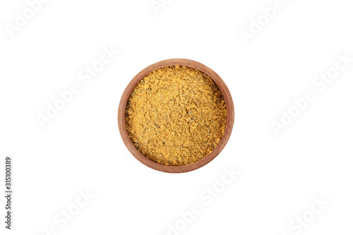 Curry powder in wood bowl isolated on white background, top view