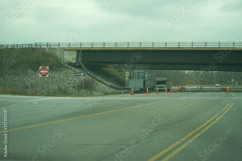 Cars standing under bridge on the highway.