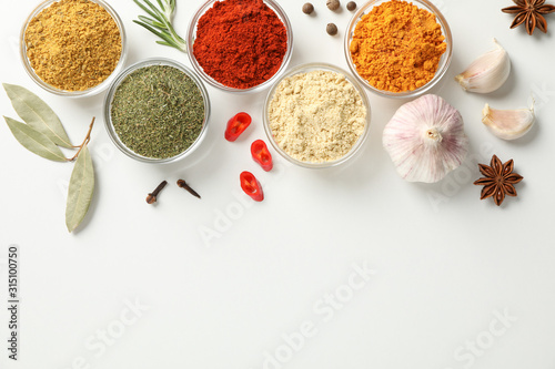 Fototapeta Naklejka Na Ścianę i Meble -  Bowls with different spices on white background, top view