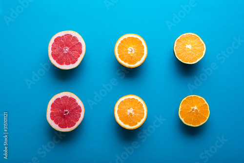 Fresh oranges and grapefruit cut in half. Halves of citrus fruit