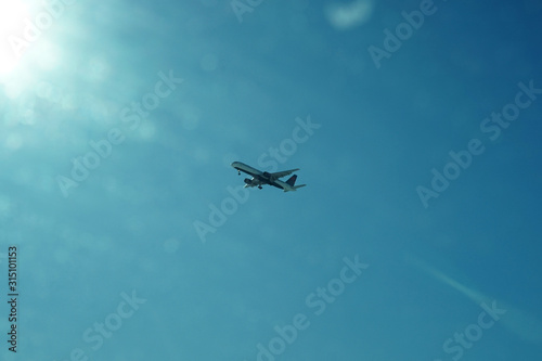 Fototapeta Naklejka Na Ścianę i Meble -  An airplane flying over blue sky.