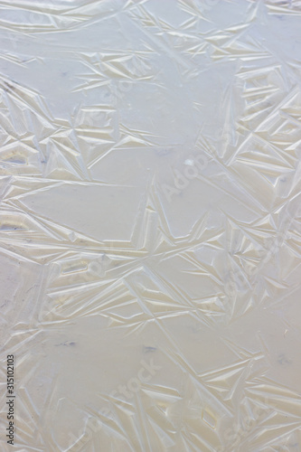 texture of thin ice on a frozen river