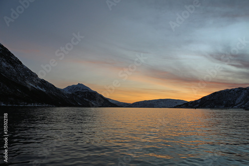 in the fjords of Norway at sunset