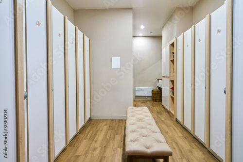 Locker room in the spa or in the gym, white lockers with electronic locks for clothes