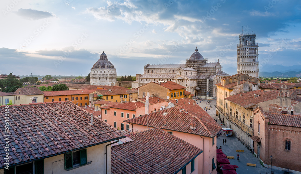 Pisa old town an sunset. View from the roofs to the old city, tower and Duomo cathedral. Toscana, Italy.