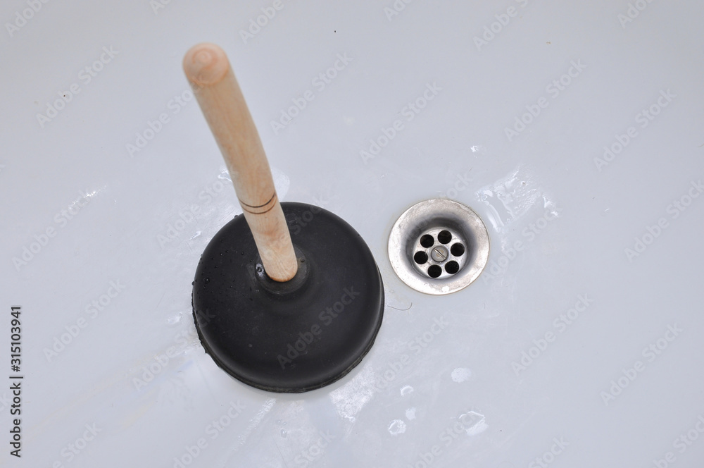 Plunger and clogged bath. Plunger and clogged bath.