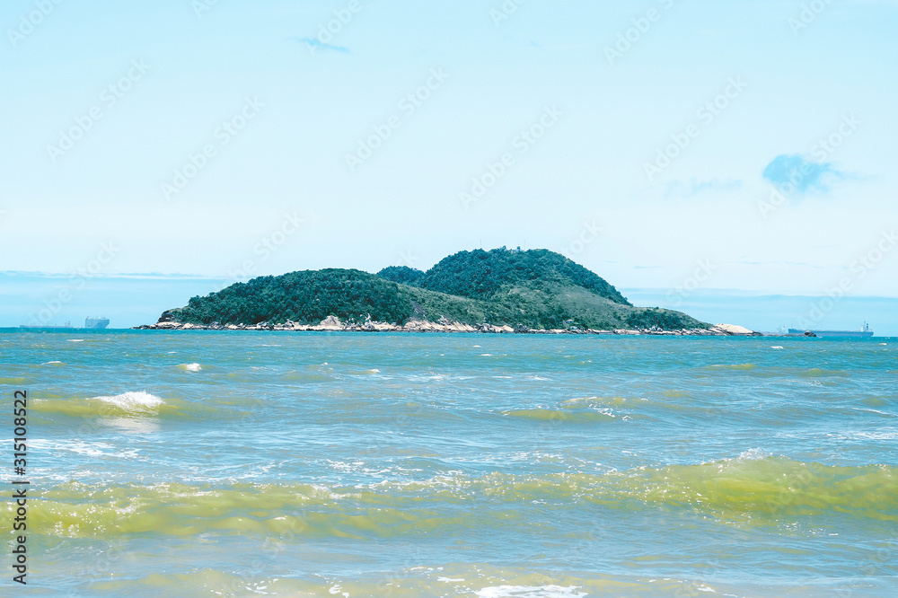 Fototapeta premium Small island in the middle of the sea. Photo of Ilha da Moela island at Guaruja SP, Brazil.