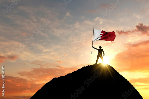 Bahrain flag being waved at the top of a mountain summit. 3D Rendering