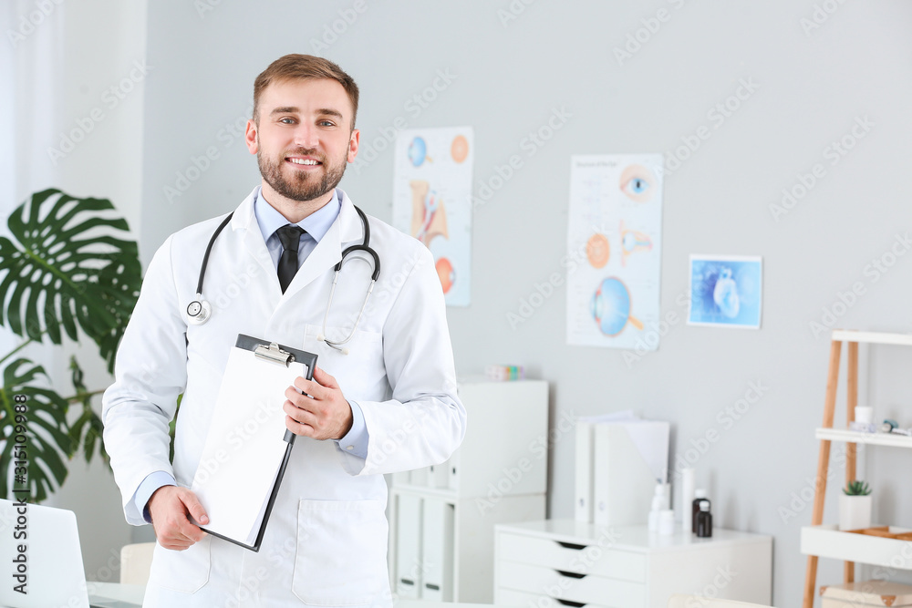 Portrait of male doctor with clipboard in clinic Portrait of male doctor with clipboard in clinic