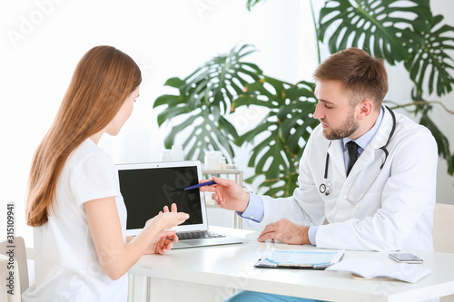 Male doctor working with fe...