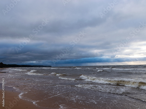 beautiful seascape, dark clouds and white waves