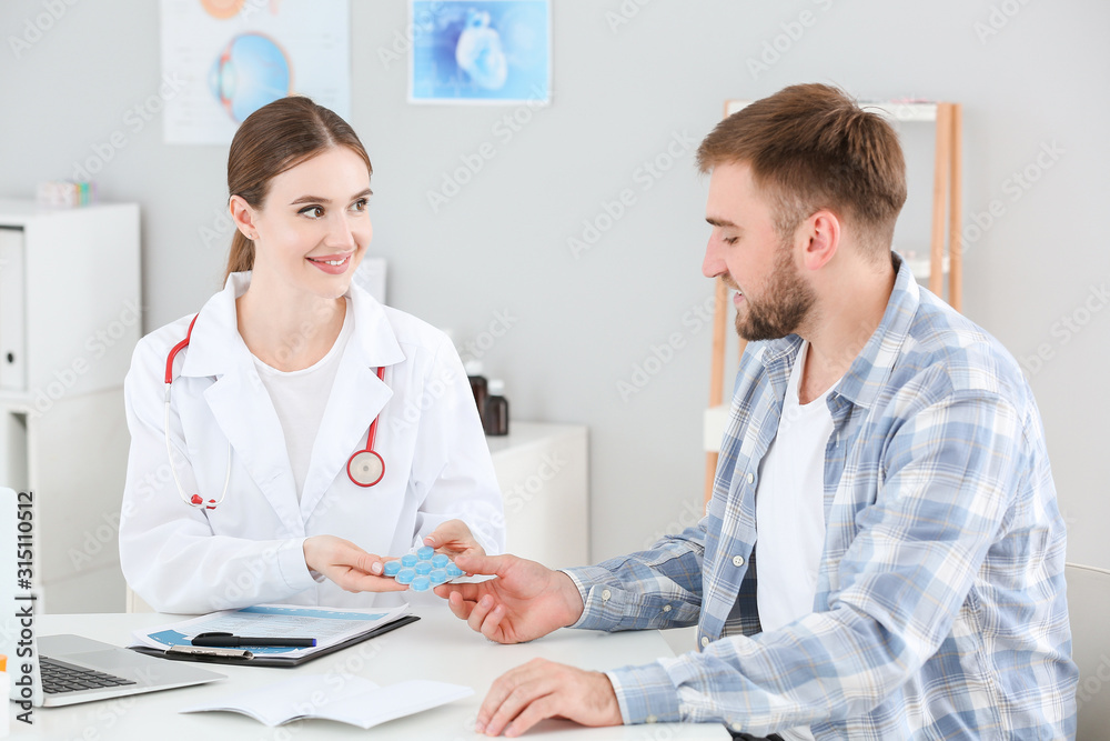 Fototapeta premium Female doctor working with male patient in clinic