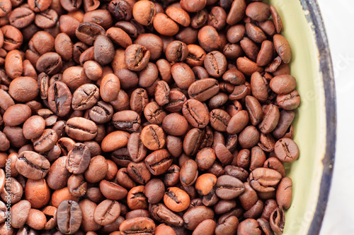 Roasted coffee beans background. Coffee beans texture. Arabica and Robusta in the morning for the coffee machine. Refreshment in the morning