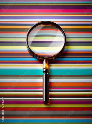 Magnifying glass on striped background