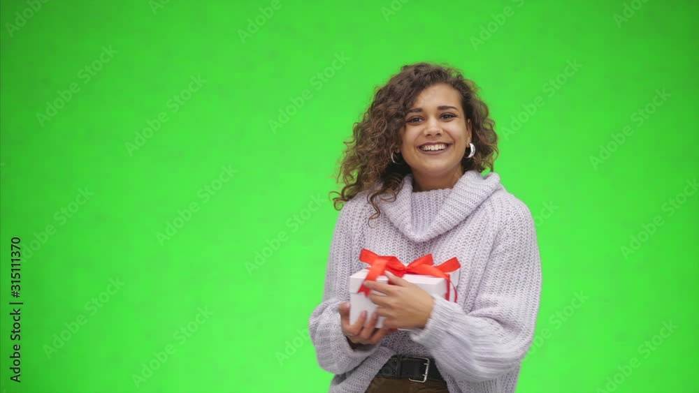 Afro-American woman is catching a giftbox with red ribbon. Best wishes. Close up. Copy space. Afro-American woman is catching a giftbox with red ribbon. Best wishes. Close up. Copy space.