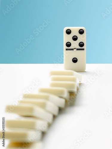 Domino toppling row of dominos
