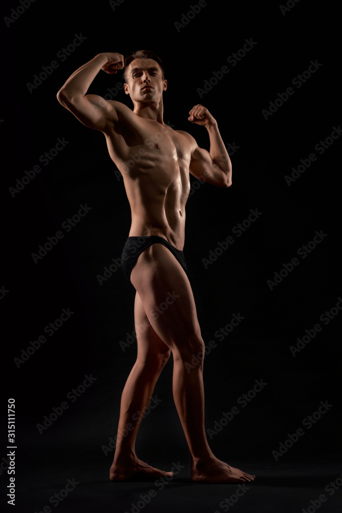 Male bodybuilder demonstrating contest pose.