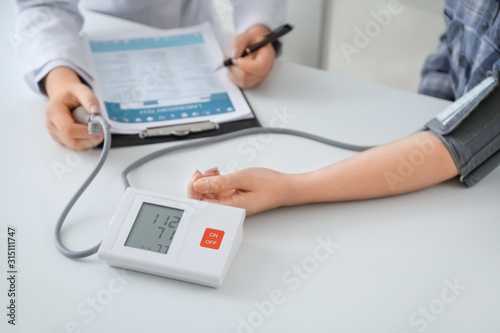 Doctor measuring blood pres...