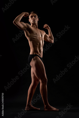 Male bodybuilder demonstrating contest pose.