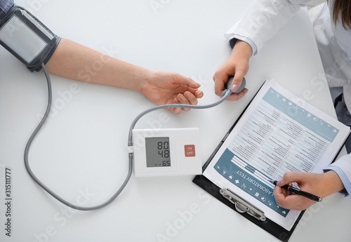 Doctor measuring blood pres...