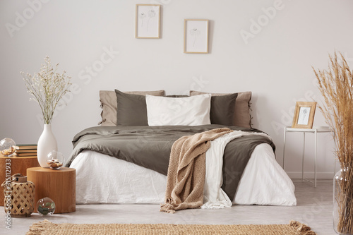 Spacious bedroom interior in beige and olive colour photo