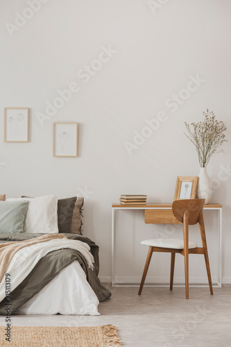 Minimal bedroom interior with desk and wooden chair