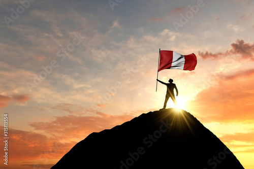 Photos Peru flag being waved at the top of a mountain summit