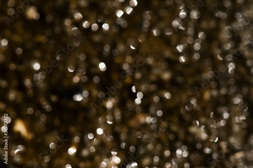Deep brown bokeh background with light.
