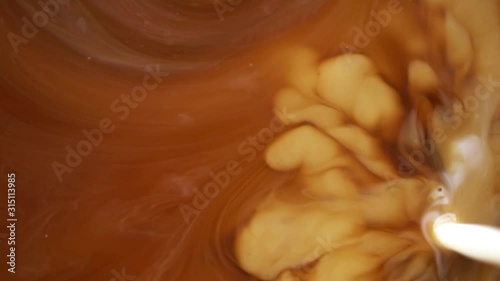 hot coffee and pouring milk cream mixing texture background for drinking concept