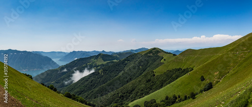 Panoramic view of Lake Como and surrounding mountains as seen from hiking trail to Monte Tremezzo