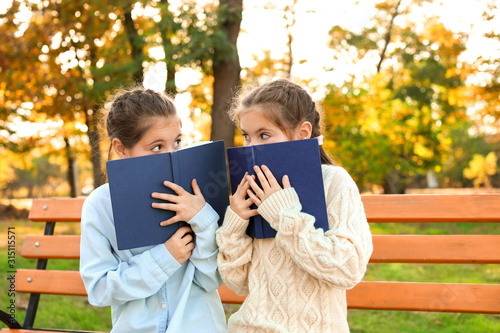 Cute little girls with book...